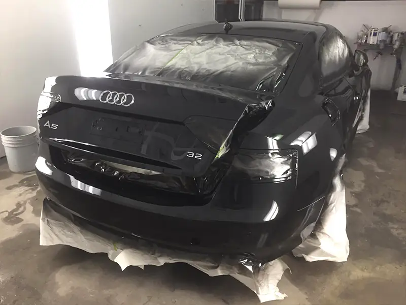 Restored Black Audi with a smooth mirror finish and modern-gloss paint after dent repair