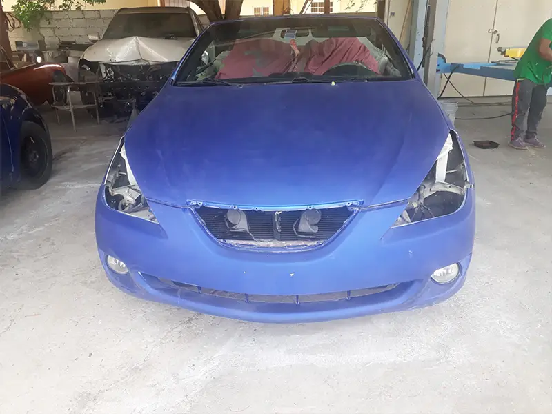 Blue auto before repainting, original color shown before makeover.