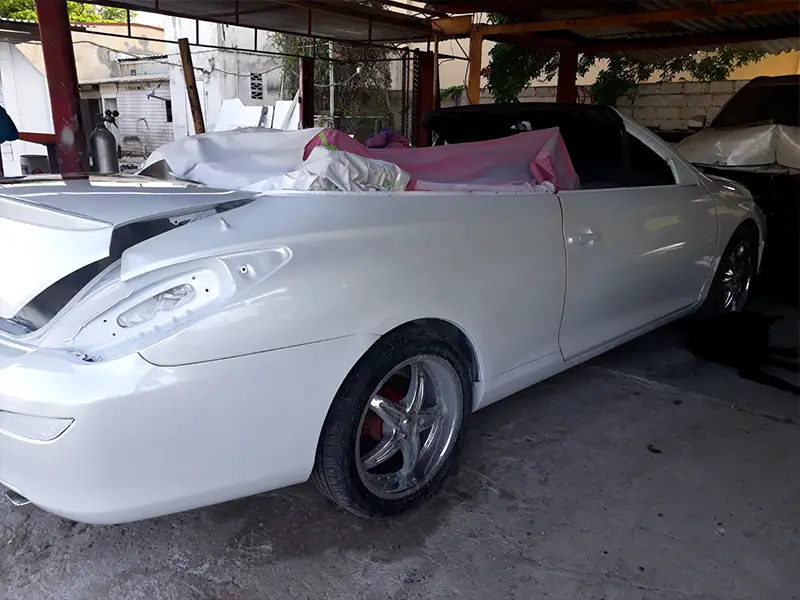 Finished auto with white paint and black stripe design.