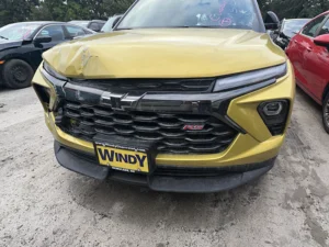 Front of a custom Gold-Lime Chevrolet showing collision impact.