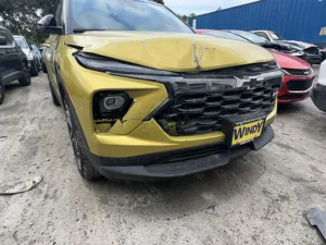 Front view of a custom Gold-Lime Chevrolet showing collision impact.
