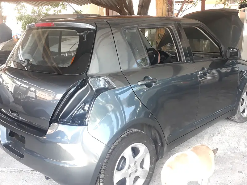 A showroom-ready gray Suzuki Swift following a complete auto body repair and repaint.