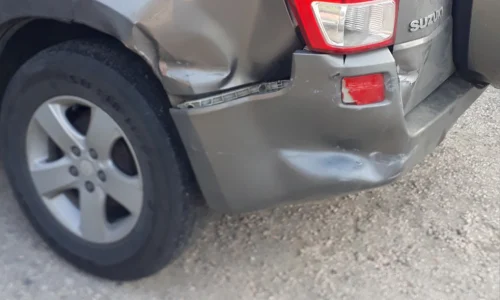 Silver SUV with rear bumper damage before Garage G&G repair it.