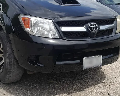 Restored black Toyota Hilux with smooth body panels and polished finish after repair